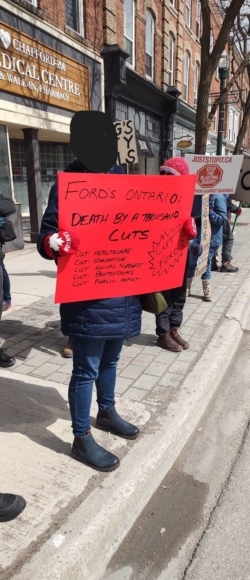 protest poster listing the various cuts doug ford has made.