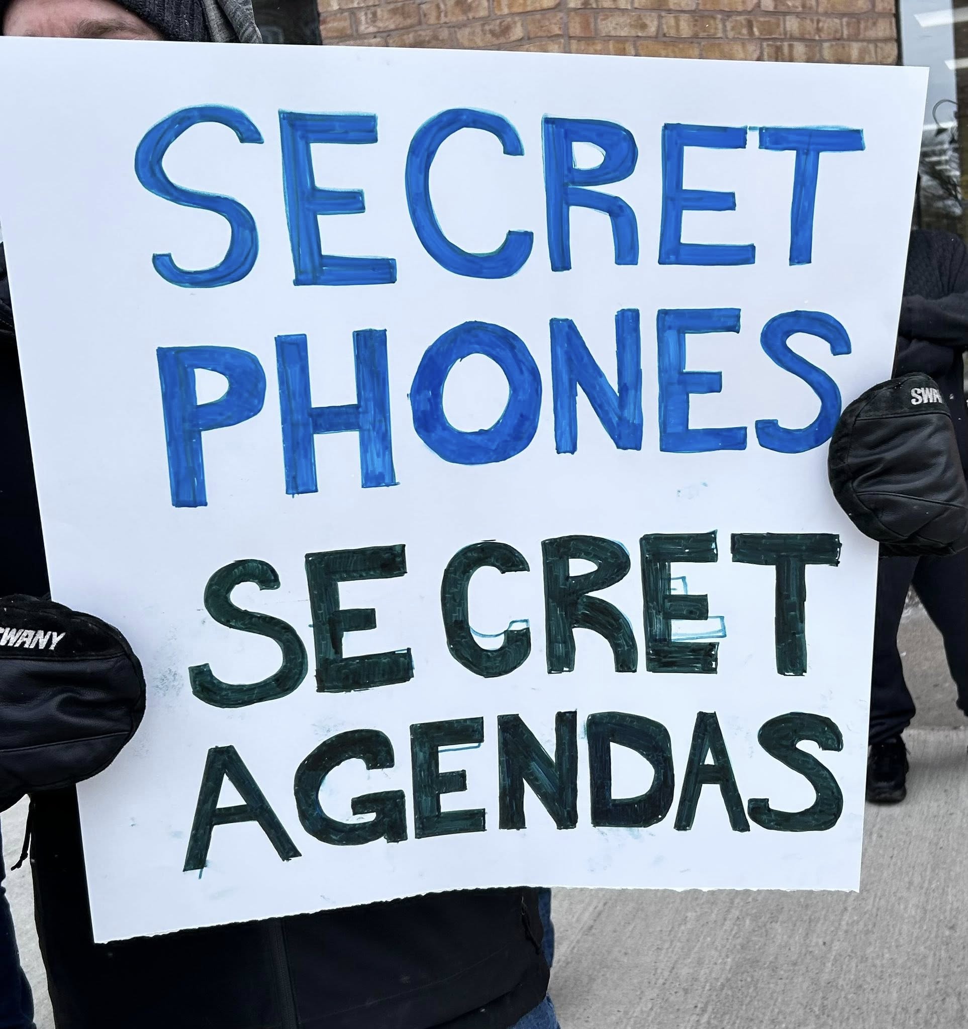 Poster saying "secret phones - secret agendas"