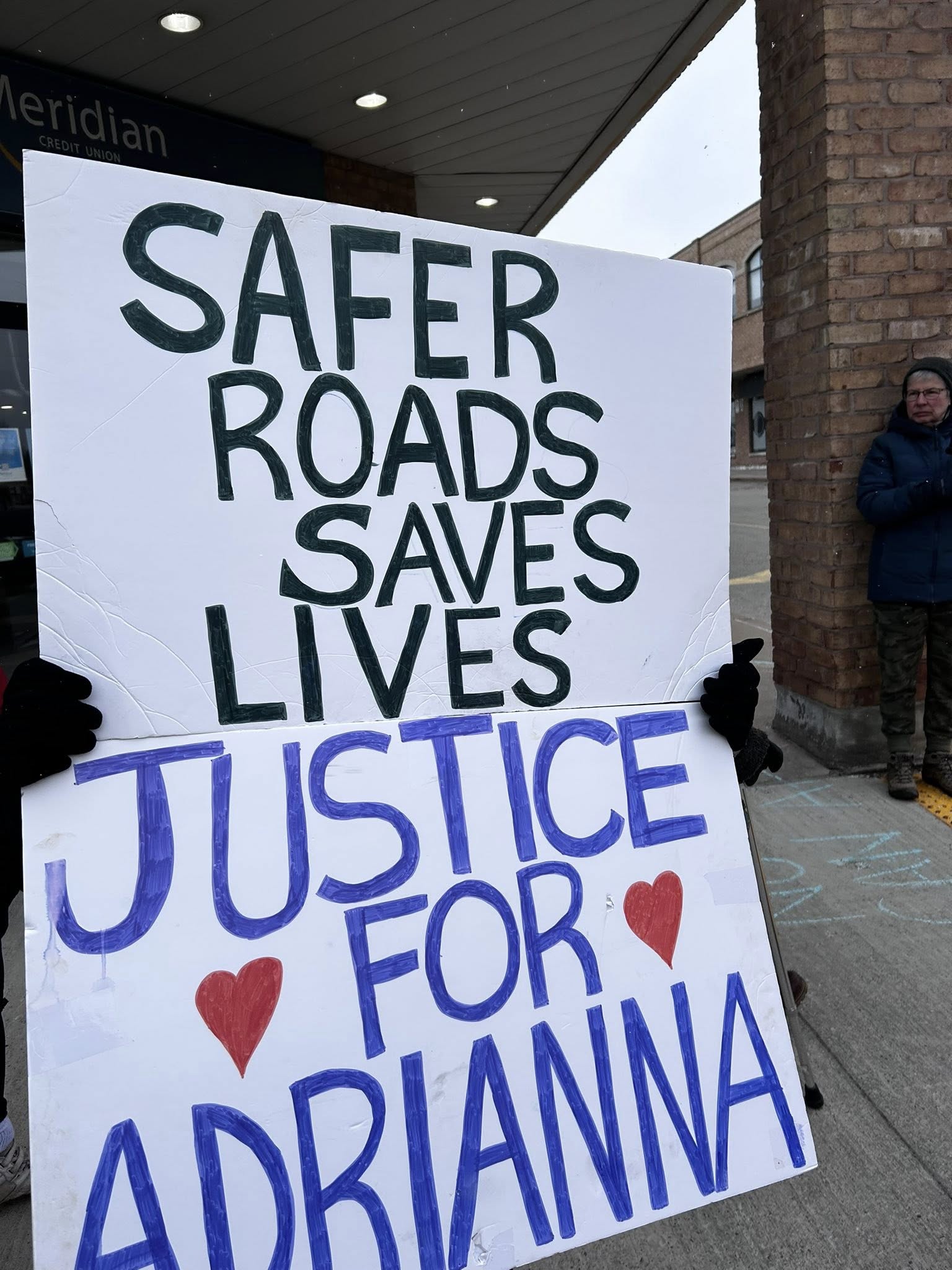 Poster saying "safer roads saves lives - justice for adrianna"