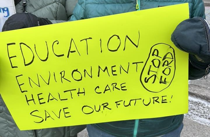 Poster sayings "education, environment, health care, save our future, and stop ford."
